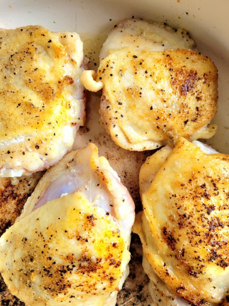 seared chicken thighs in a skillet