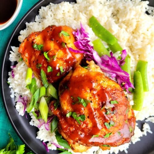 Slow Cooker Asian Chicken Thighs are sticky, sweet, and savory with garlic, ginger, soy sauce, and Sriracha. This easy crockpot chicken recipe is fall-apart tender, better than takeout, and perfect for busy weeknight dinners or meal prep.