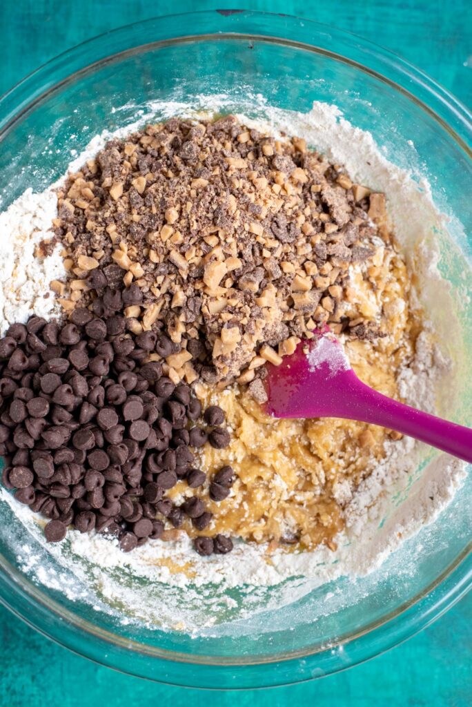adding toffee and chocolate chips to cookie batter