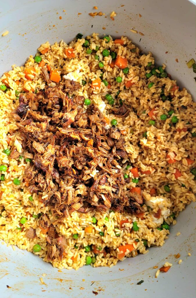 adding the leftover smoked pork to the fried rice