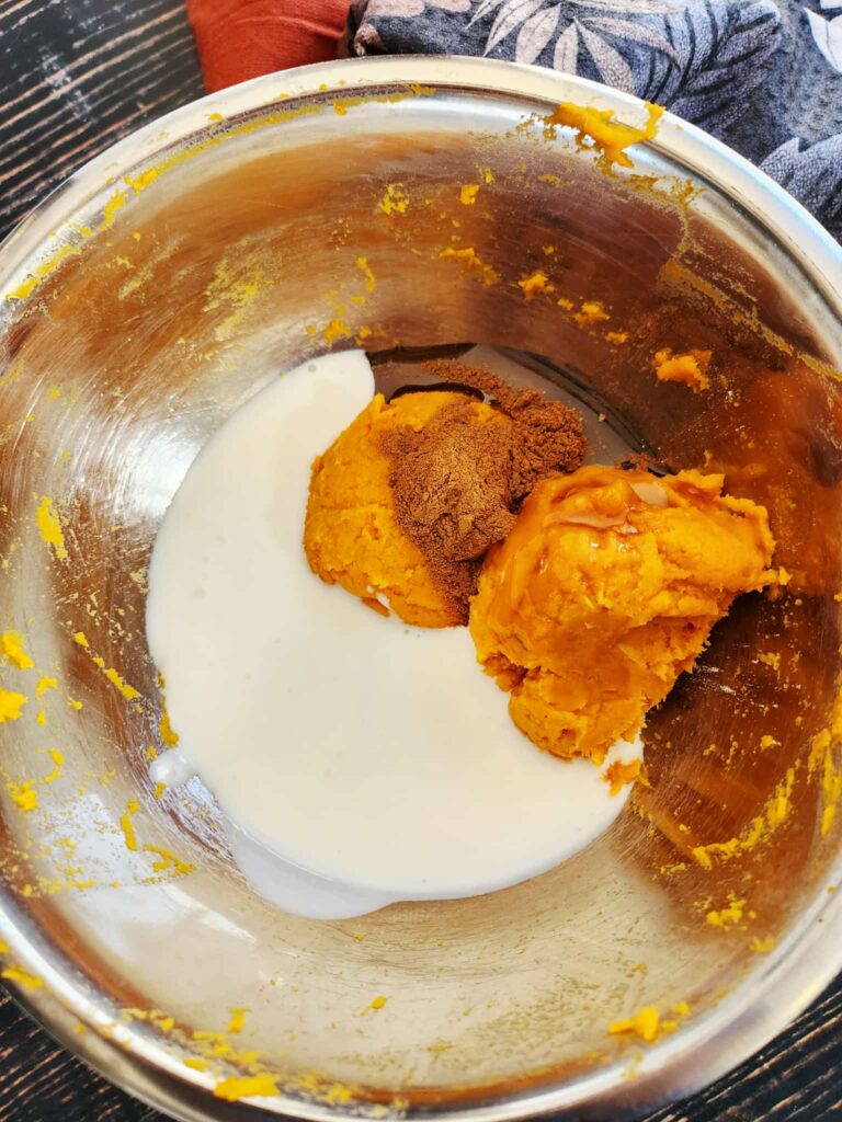 adding wet ingredients and sweet potato to biscuit dough