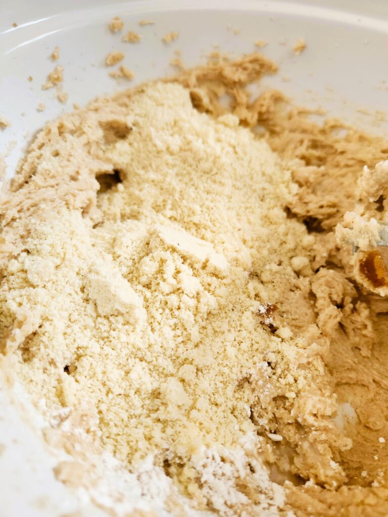 adding almond flour to cookie dough