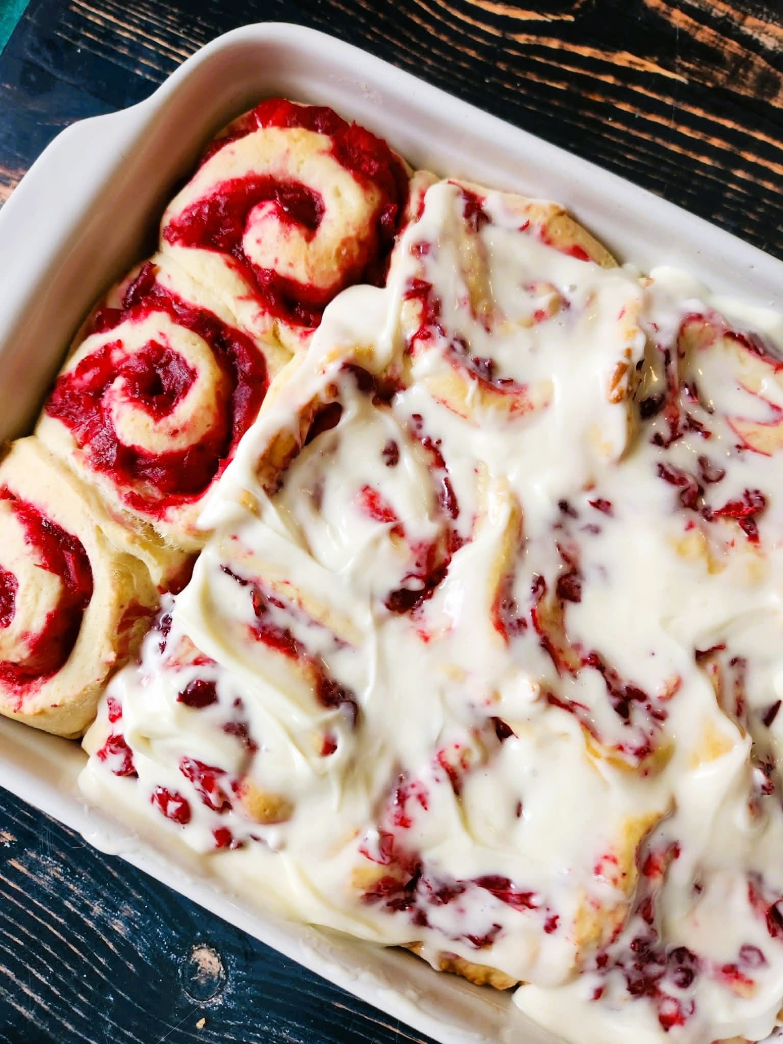 Freshly baked cranberry orange cinnamon rolls in a 9×13-inch pan, golden brown and fluffy.”