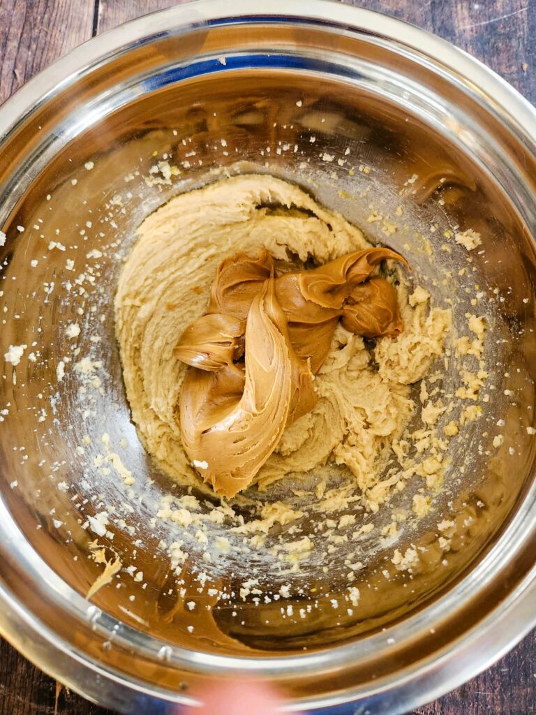 adding peanut butter to the cookie dough