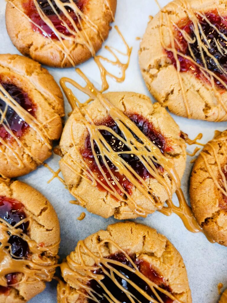 Baking soft peanut butter and jelly cookies on parchment-lined sheet