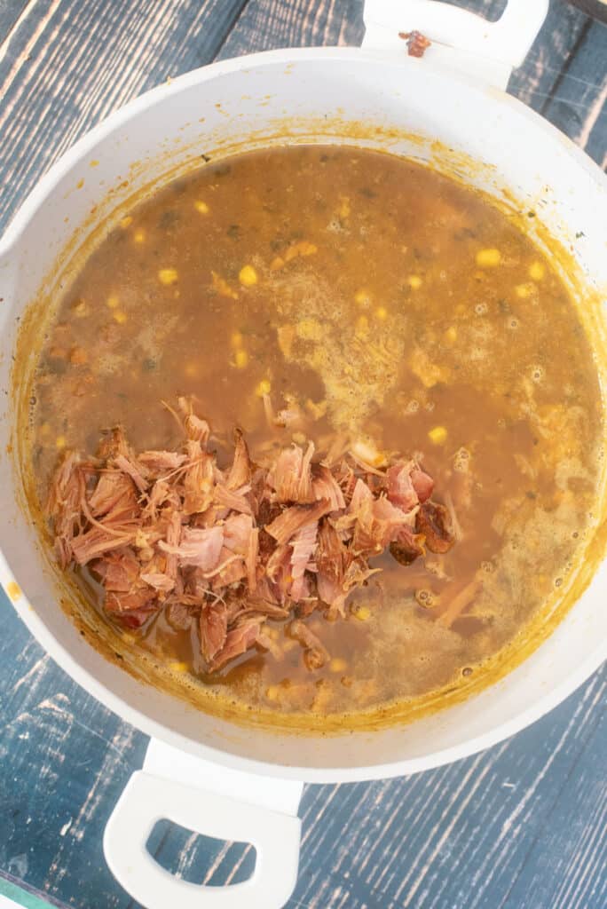 stirring ham into bean soup