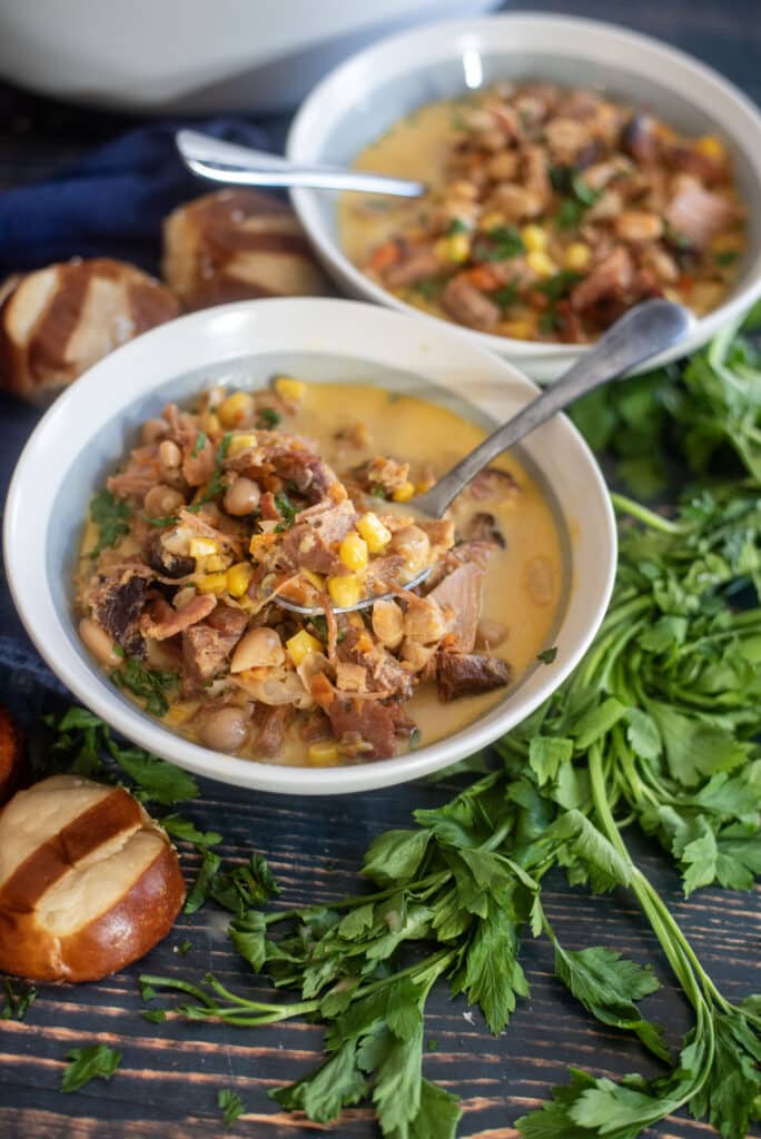 Hearty ham white bean soup with ham hocks and a ham bone. Easy ham and bean soup recipe using canned beans turns out creamy, smoky, and perfect comfort food every time.