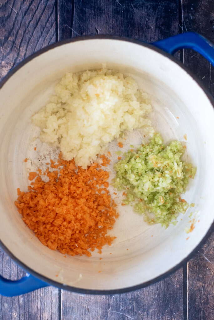 Sautรฉing onions, carrots, and celery for the base of an easy beef bolognese recipe
