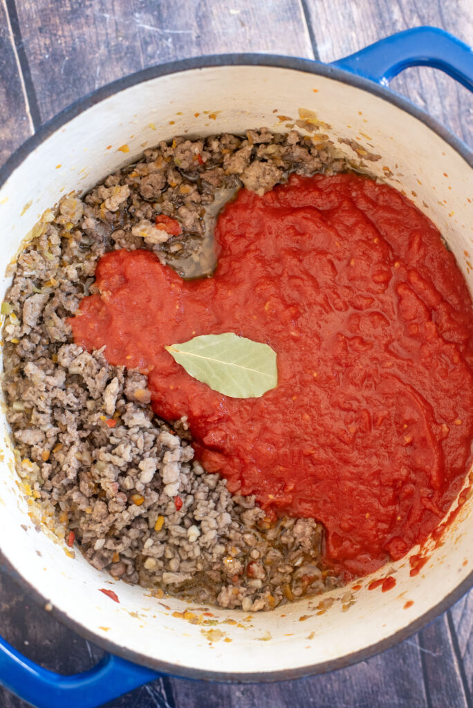 Simmering homemade beef bolognese sauce slowly to meld flavors