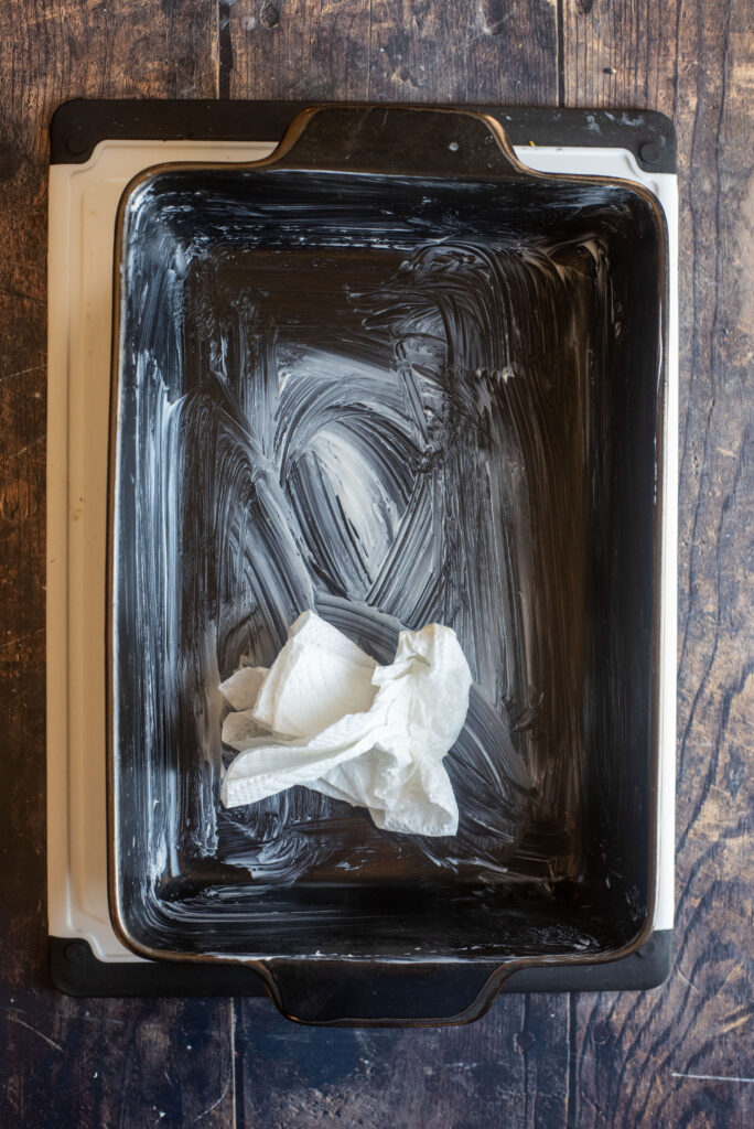 buttering baking pan for garlic rolls