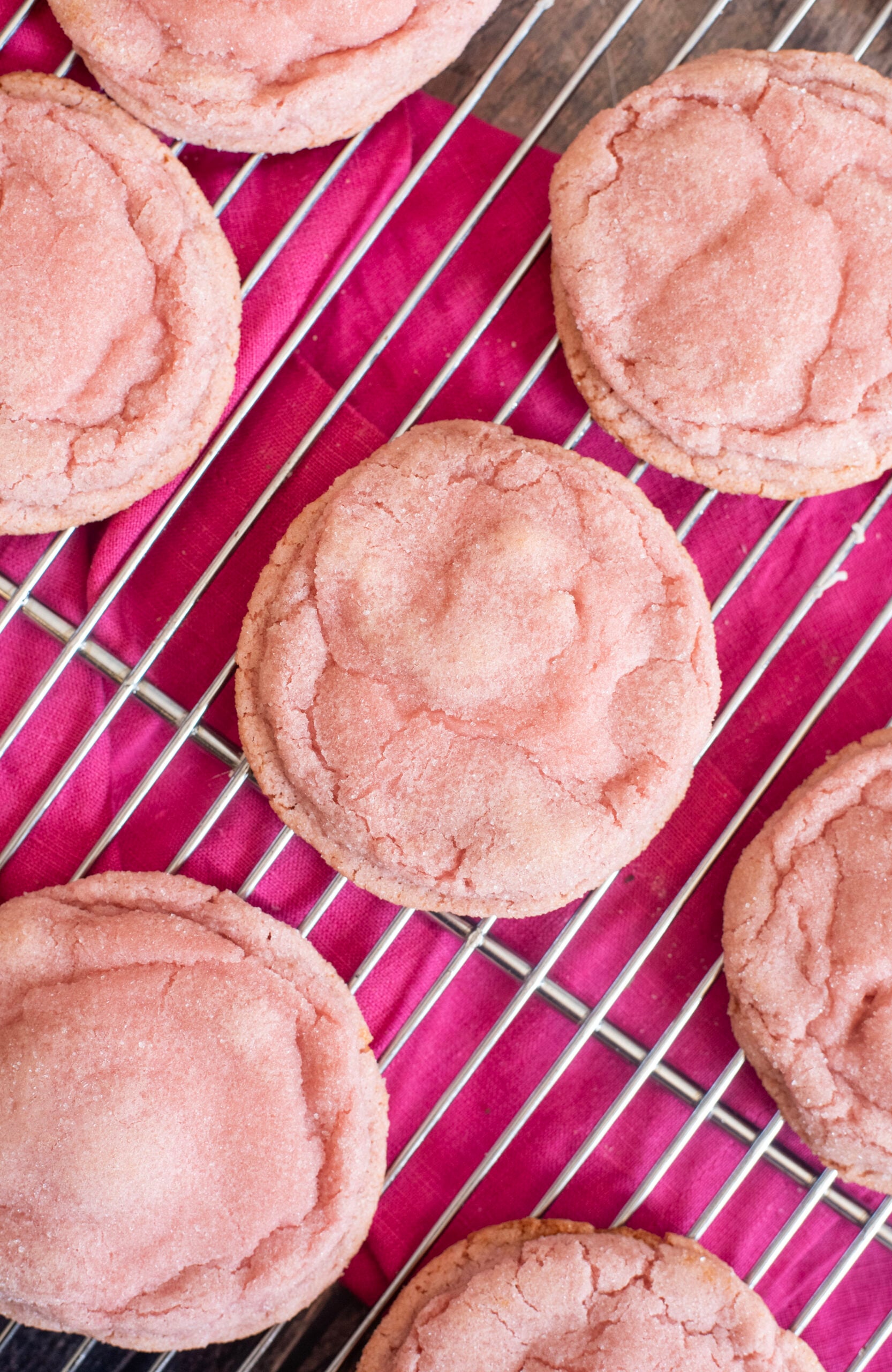Soft, chewy pink strawberry crinkle cookies made with real homemade strawberry syrup. Perfect homemade Valentine’s Day treat or dessert for gifting and parties.