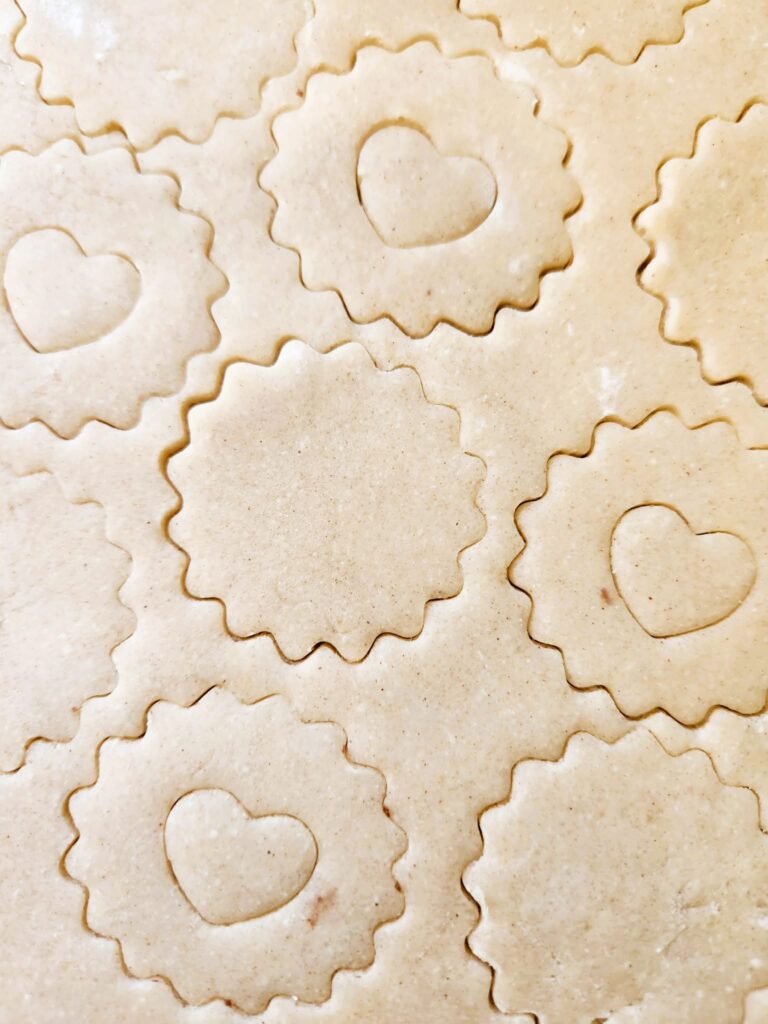 Cutting shapes from chilled dough for Raspberry Linzer Cookies.