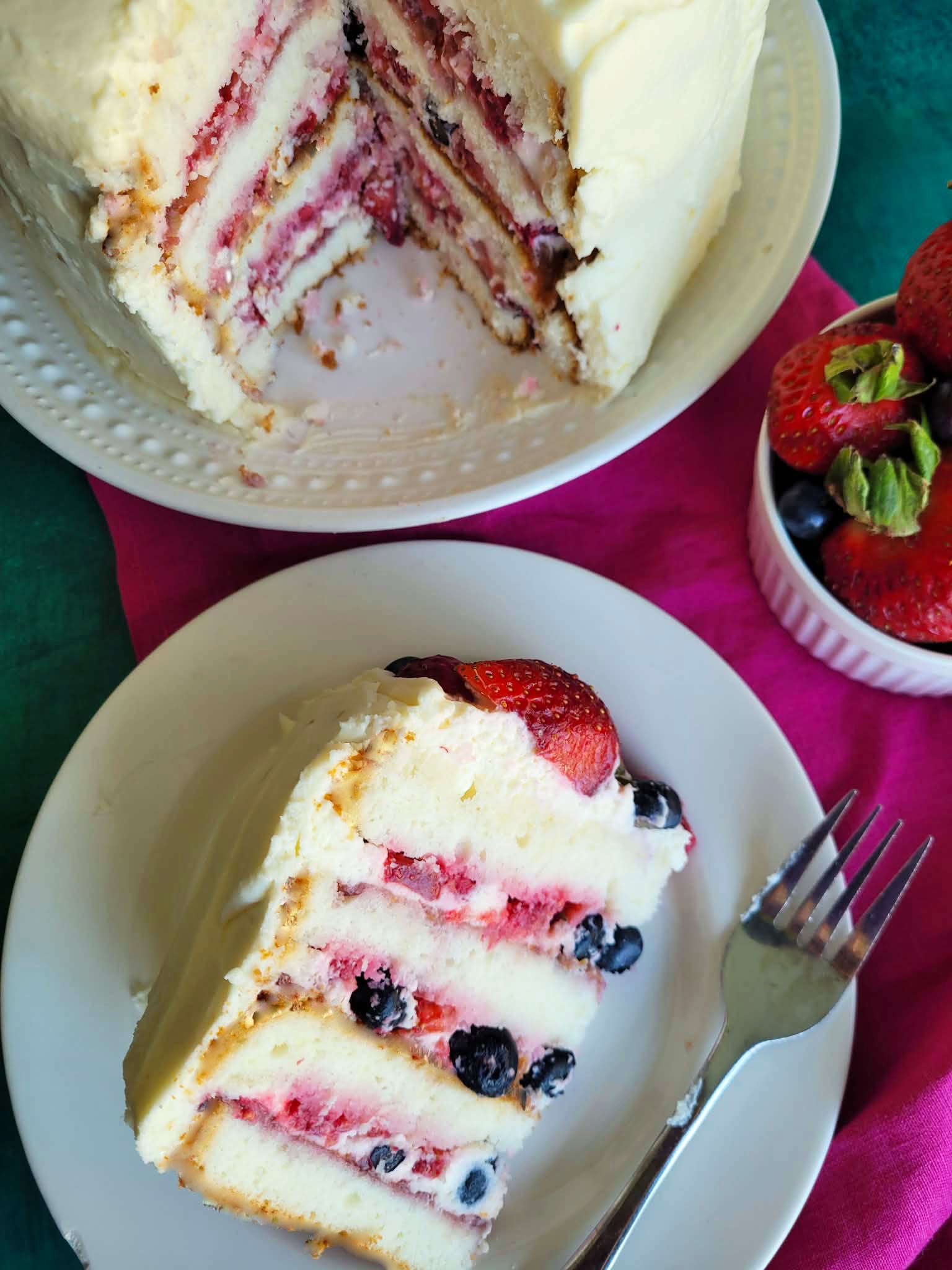 This Berry Chantilly Cake recipe uses vanilla cake mix, fresh berries, almond flavor, and mascarpone whipped cream frosting for a soft, bakery-style layer cake perfect for spring, Easter, or special occasions.