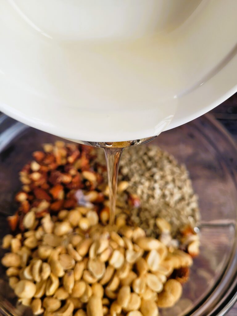 Combining corn syrup and sugar in saucepan to make homemade almond crunch bars