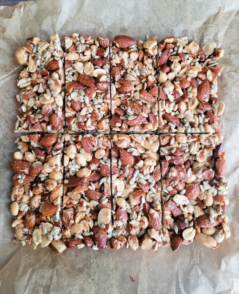 Tray of homemade almond crunch bars cut into squares, ready to snack.