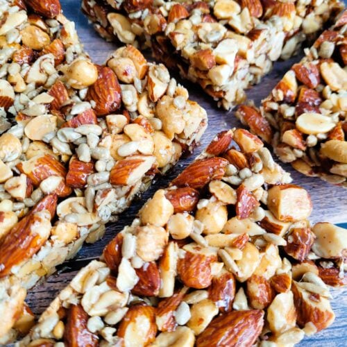 Close-up of homemade almond crunch bars showing crunchy nuts and golden binding.