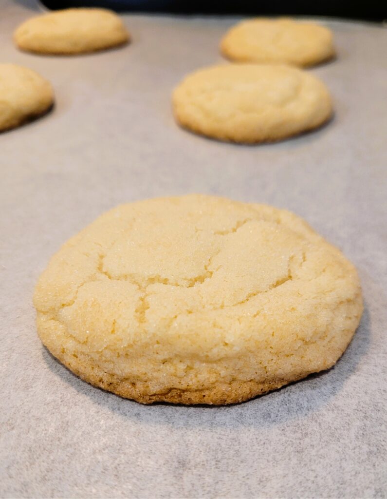 Close-up of bakery-style sugar cookies showing soft centers and crackly sugar top