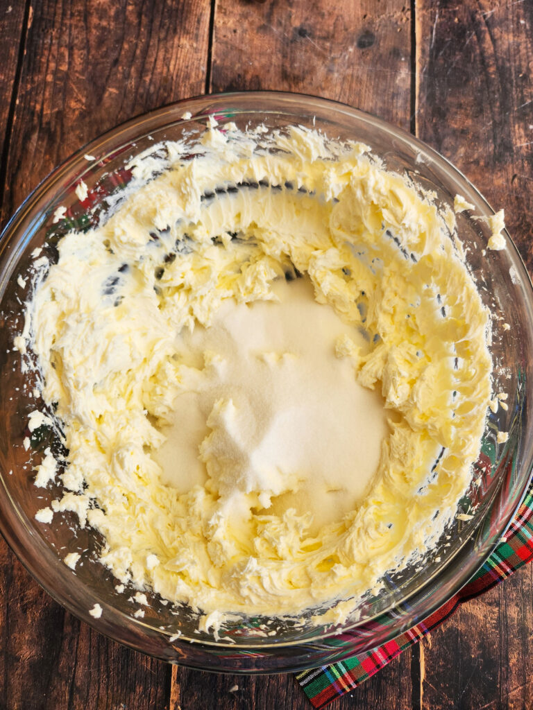 beating sugar and cream cheese together for cheesecake batter