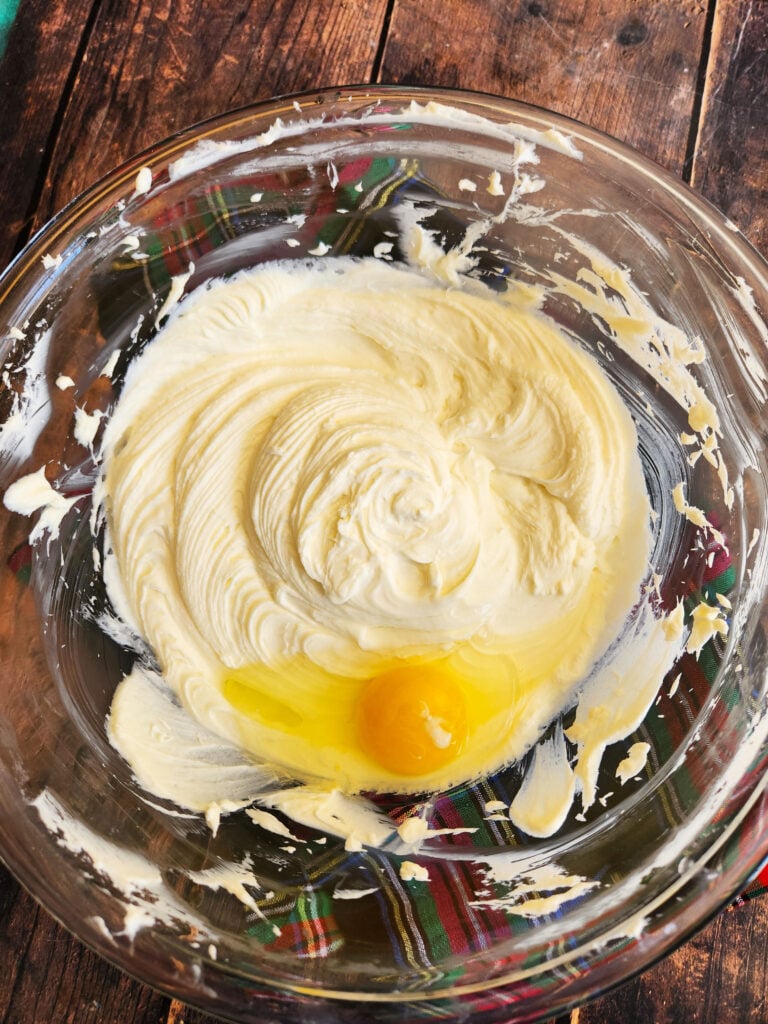adding eggs to cheesecake batter