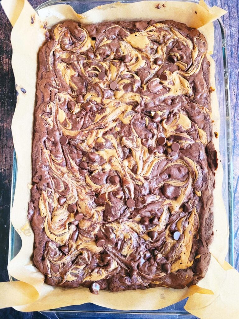 Tray of freshly baked peanut butter chocolate brownies with melty chocolate chips on top