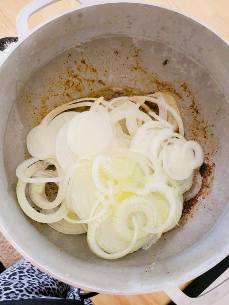 sliced onions in a pan to be carmelized