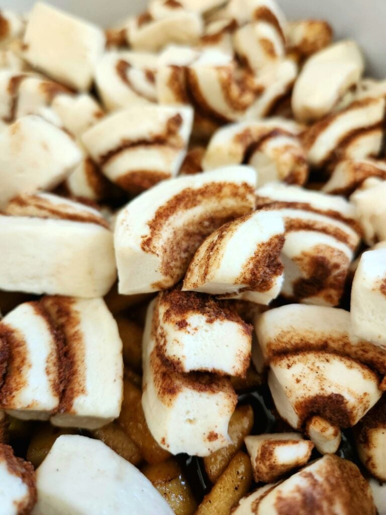 Refrigerated cinnamon rolls cut into quarters in a greased 9x13 baking dish