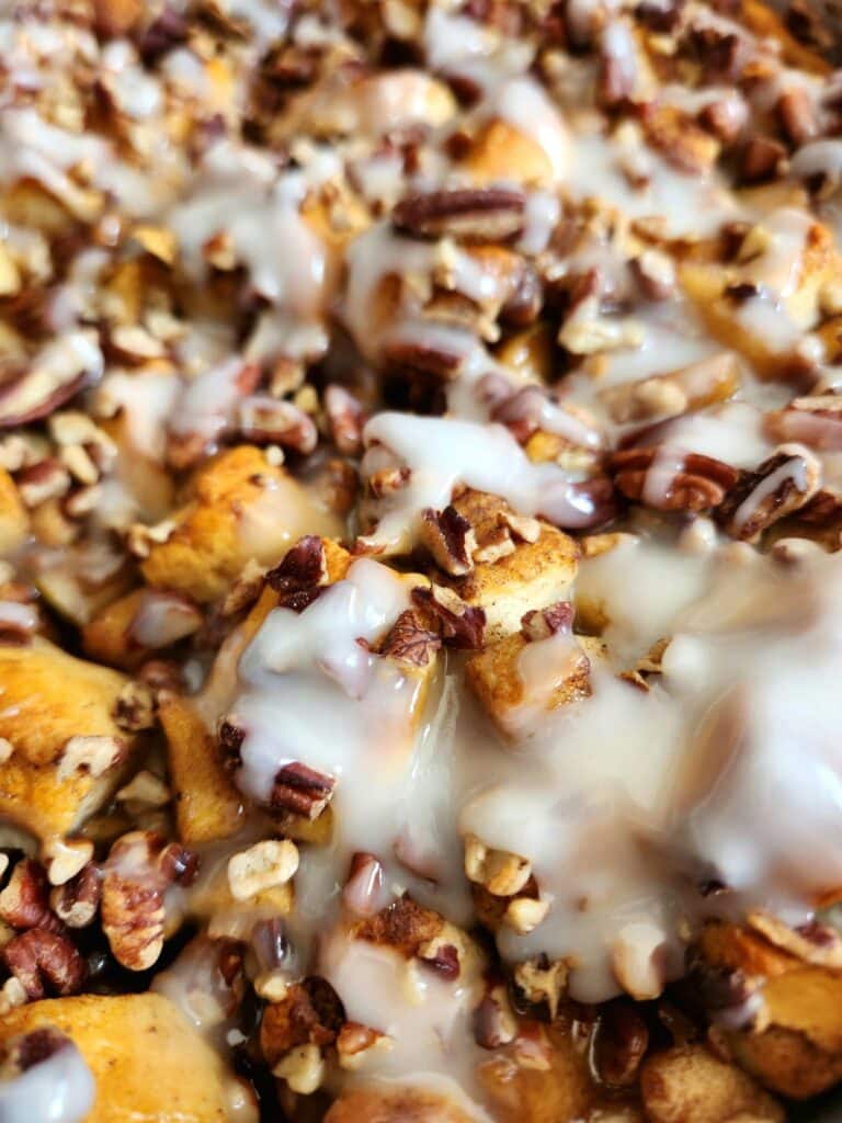 This easy apple cinnamon roll casserole combines refrigerated cinnamon rolls, buttery cinnamon apples, pecans, maple custard, and extra icing for the ultimate cozy fall or holiday breakfast.