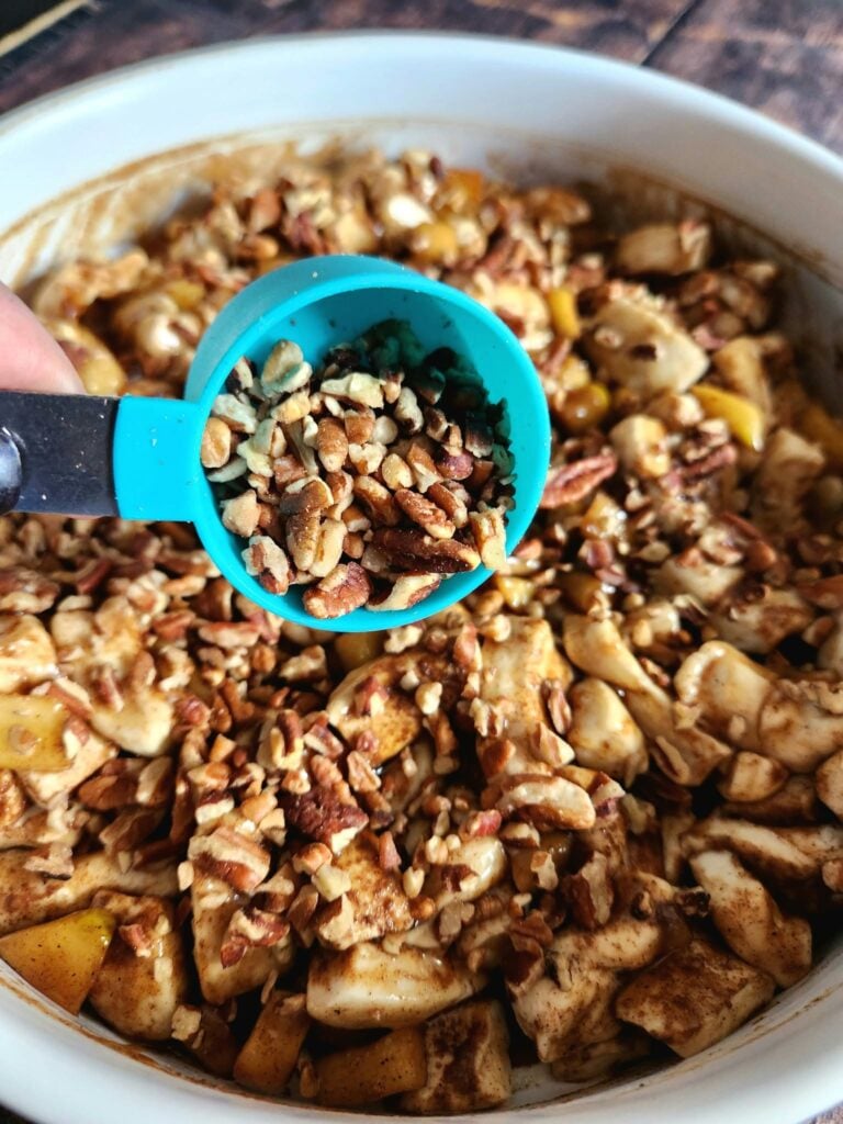 Cinnamon apples and chopped pecans layered over cut cinnamon rolls