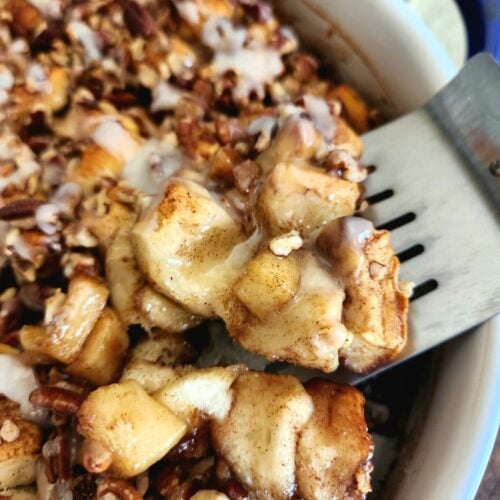 This easy Apple Cinnamon Roll Casserole combines refrigerated cinnamon rolls, buttery cinnamon apples, pecans, maple custard, and extra icing.