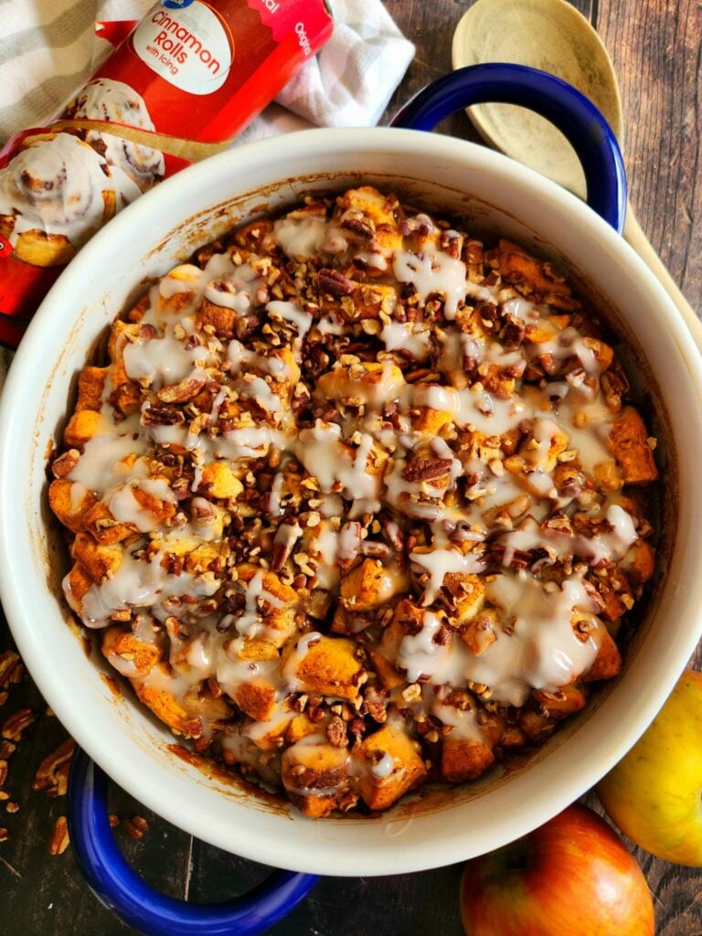 gooey cinnamon roll casserole with tender cinnamon apples and icing